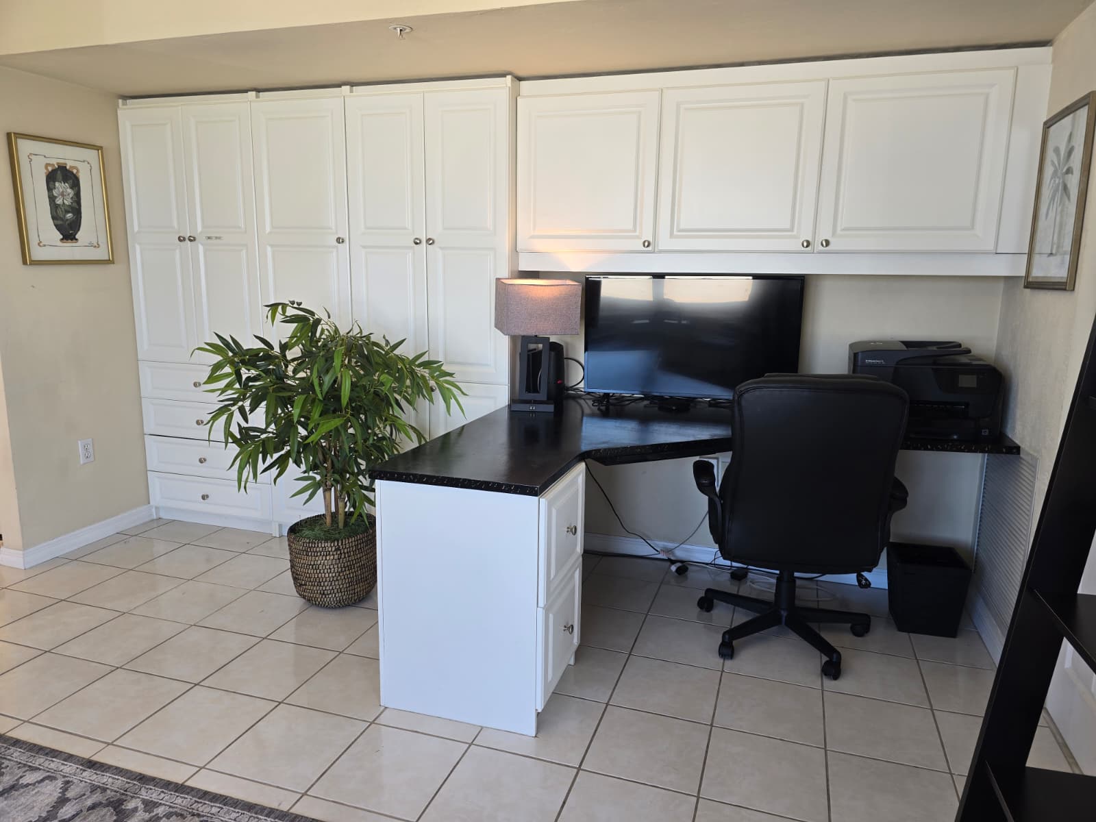 Office desk with roller chair and computer monitor